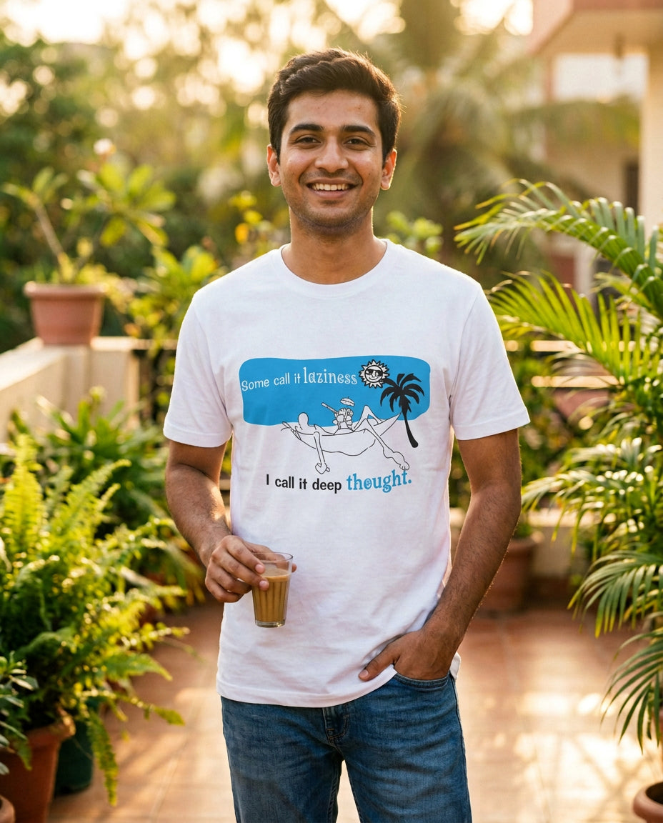 Young man wearing an Offbeat AB 026 white T-shirt with 'Some call it laziness, I call it deep thought' cartoon graphic